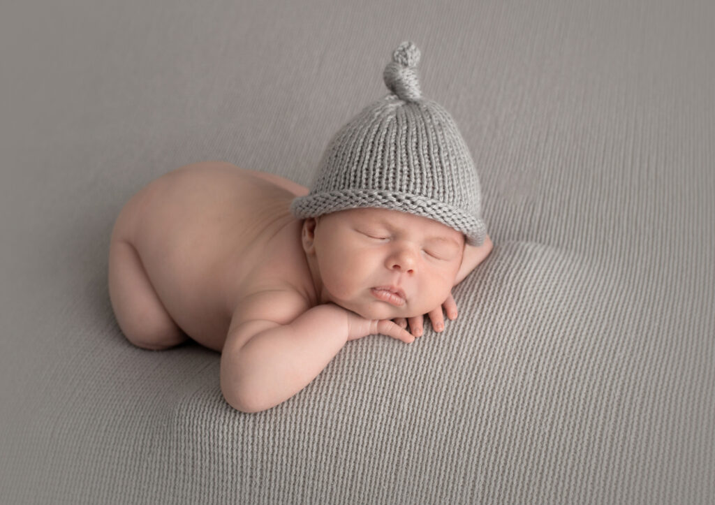 "adorable newborn baby peacefully posed and sleeping"